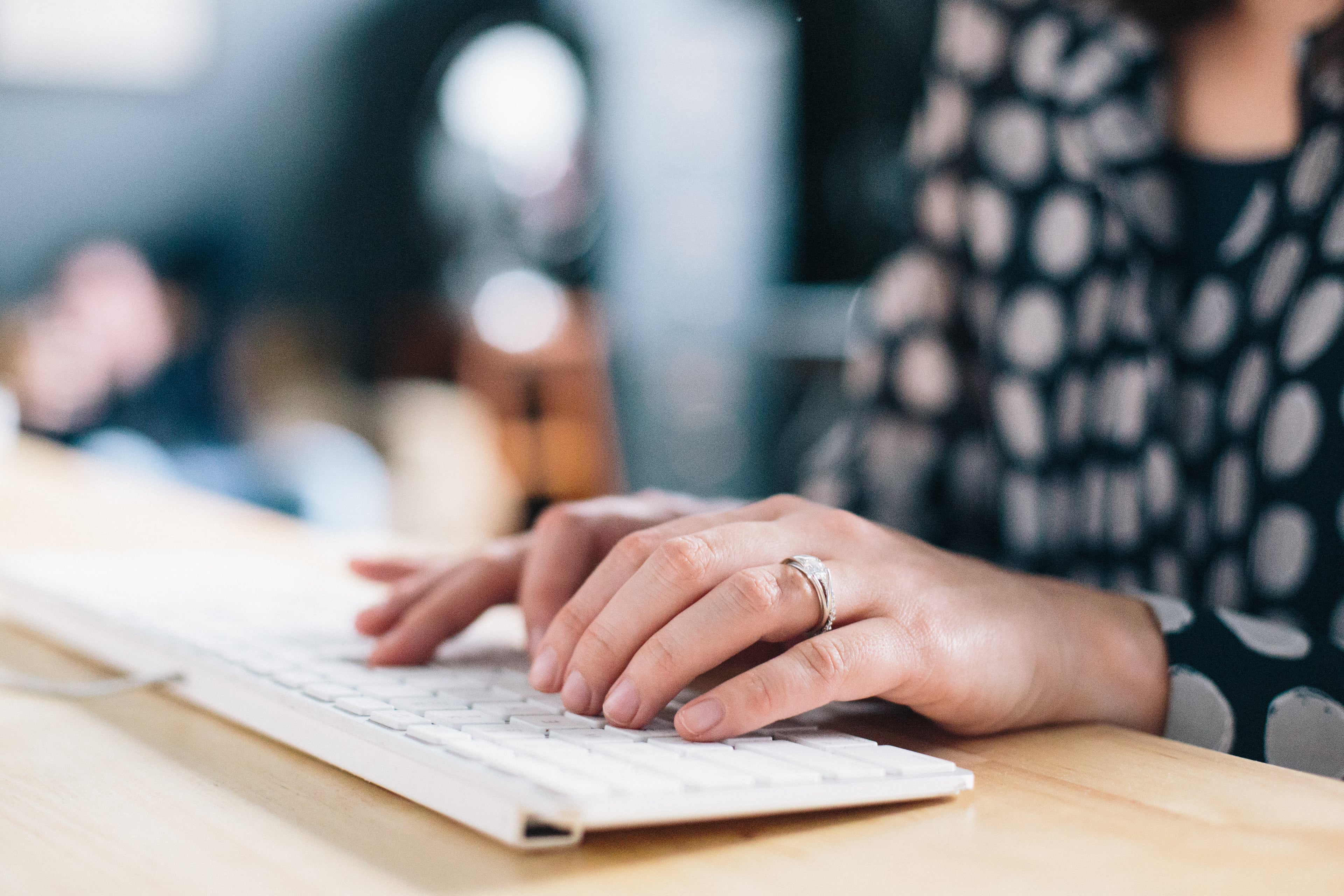 female working at a desk using a keyboard